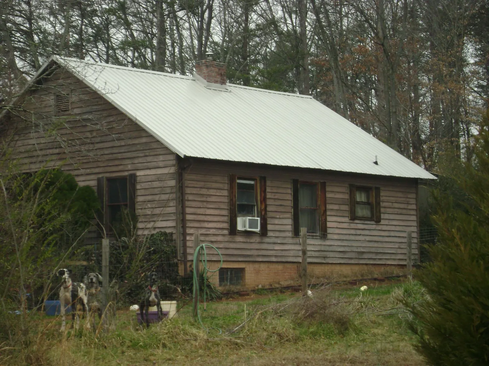 White metal roof on an old wood sided farmhouse, from a Metal Roof Installation job in Sterling Forest